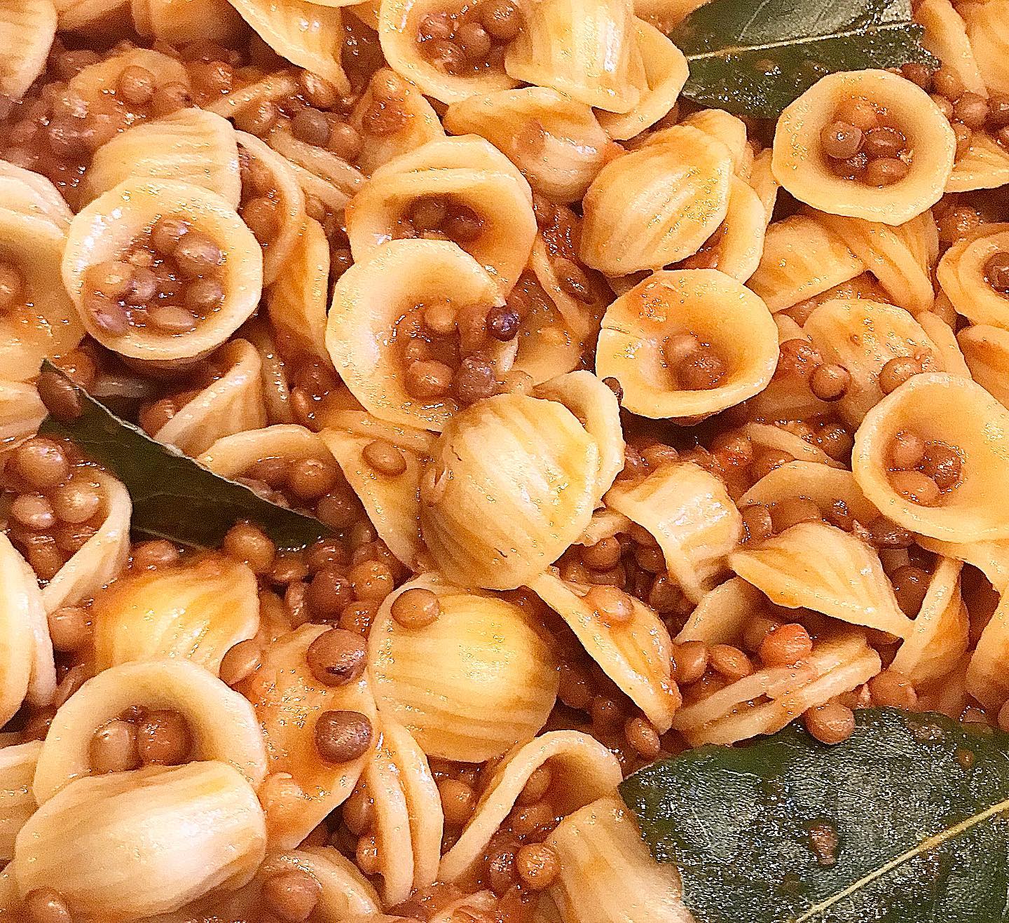 Foto della Ricetta delle Orecchiette con le Lenticchie, condite con qualche goccia di concentrato di pomodoro e impiattate con delle foglie di alloro