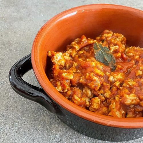 Foto della ricetta di ragù di pollo con passato di pomodoro, cipolla rossa, alloro, timo, salvia, ginepro e vino bianco